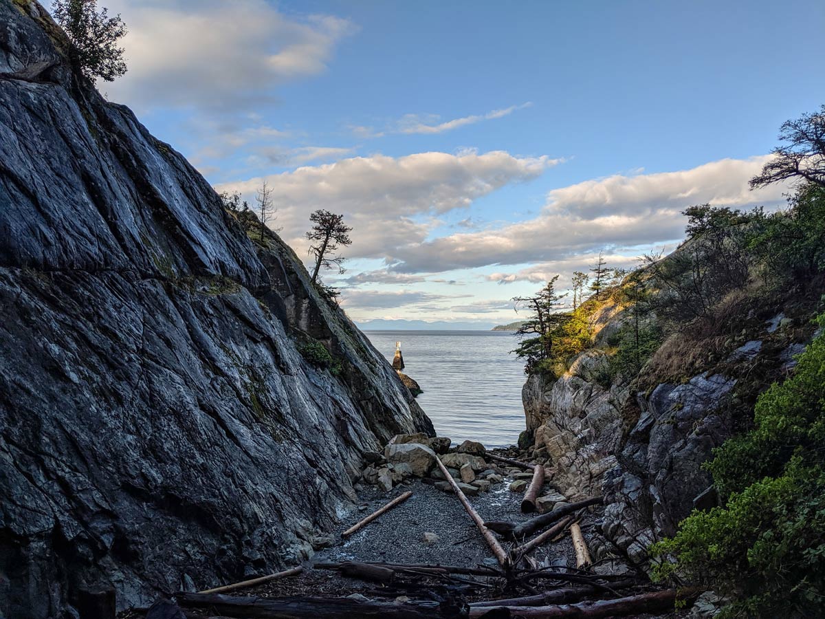 Looking out to the sea through crack in rock at Whytecliff Park in North Shore
