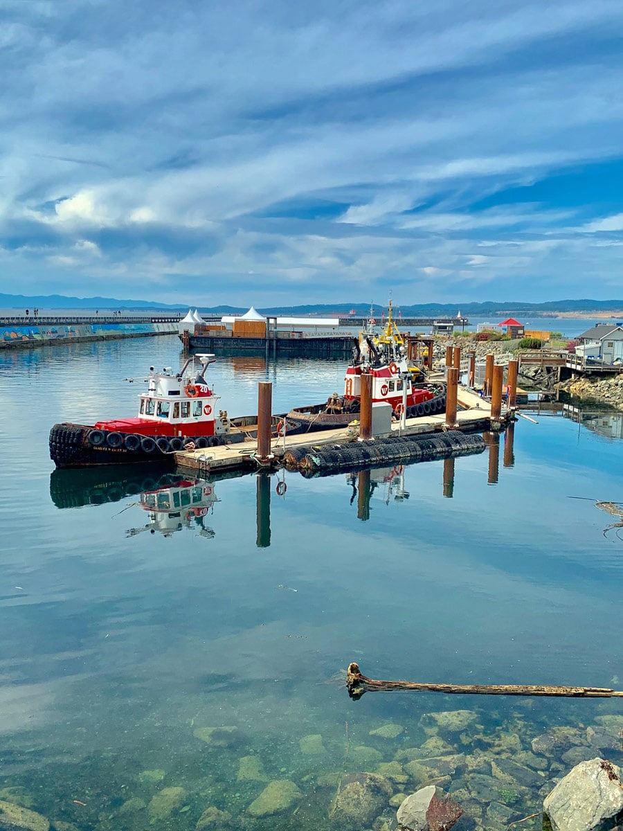 Boats moored in Turquoise waters at Ogden Point hiking the best trails around Victoria