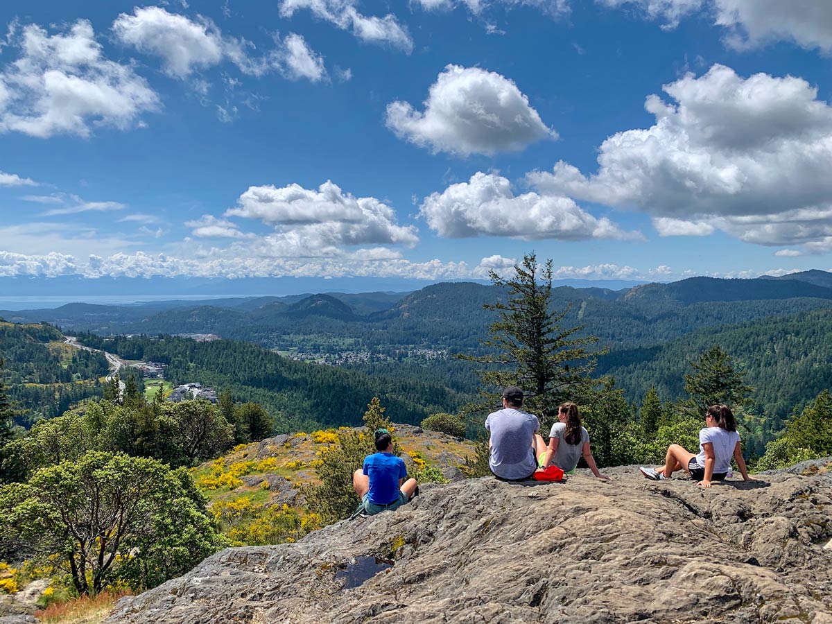 Hikers rest atop one of the best hikes near Victoria BC up Mount Finlayson