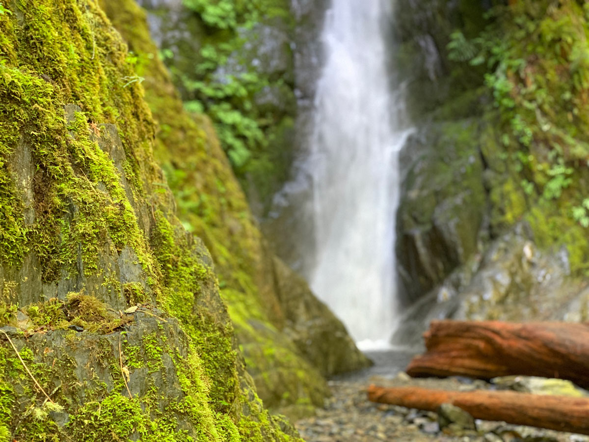 Mossy rockas around waterfall along beautiful Goldstream to Trestle trail near Victoria