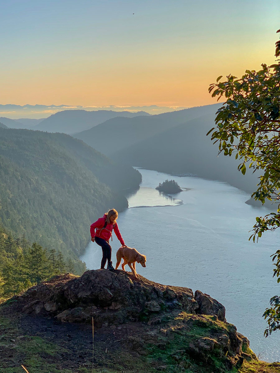 Hiker and dog on Jocelyn Hill one of the best hikes near Victoria