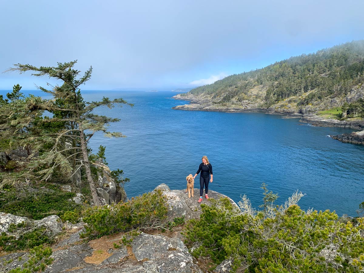 Woman and dog hiking in Sooke on one of the best hikes near Victoria