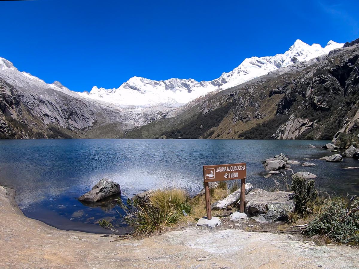 Lake Auquicocha laying at the base of a glacier