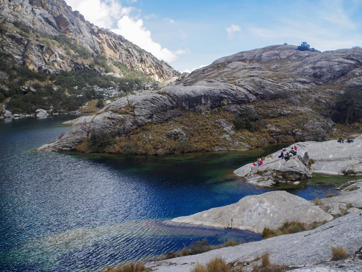 Hikers enjoy rocky Lake Churup shores