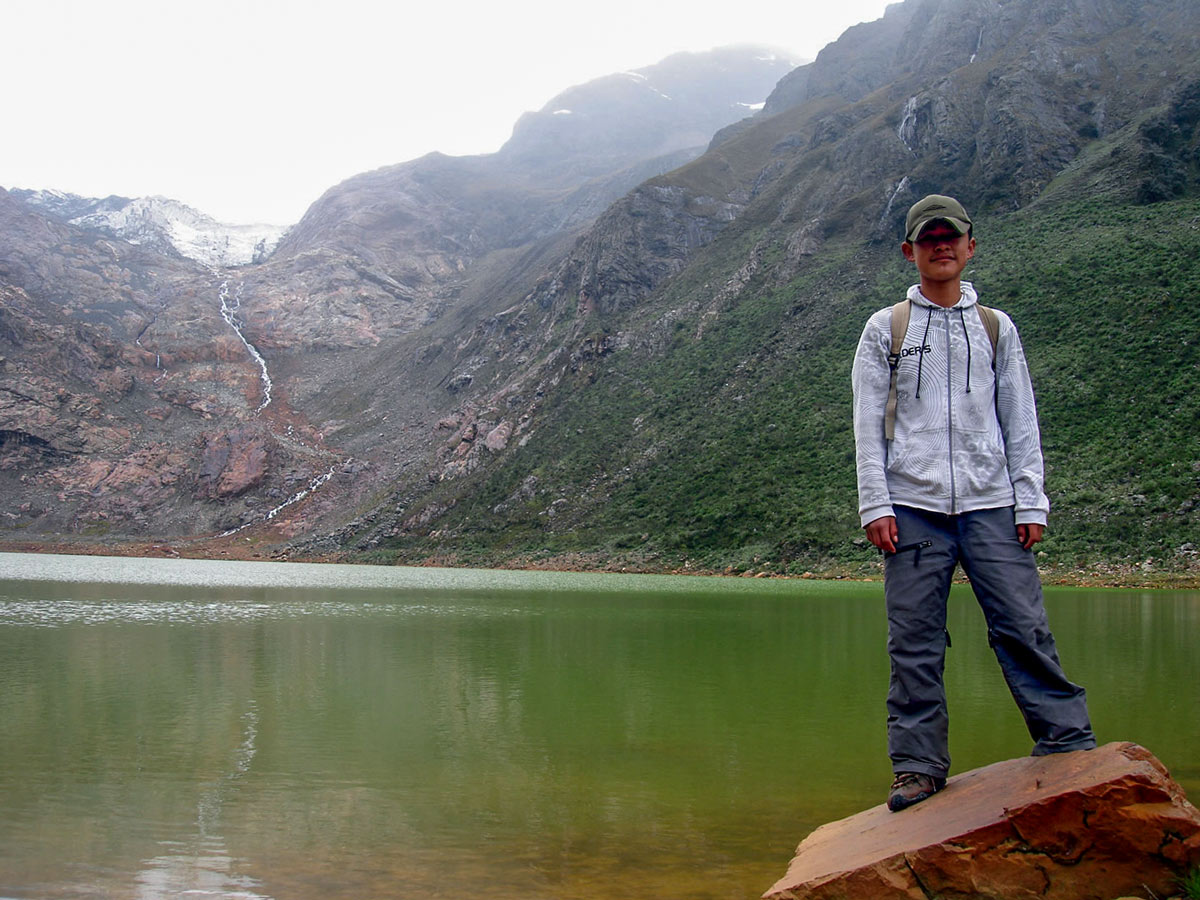 Hiker stands by Lake Shallap