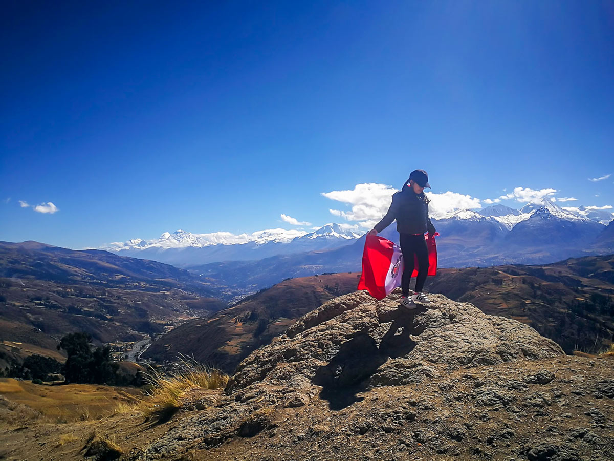 Hiker flies flag from Wilkacocha Viewpoint