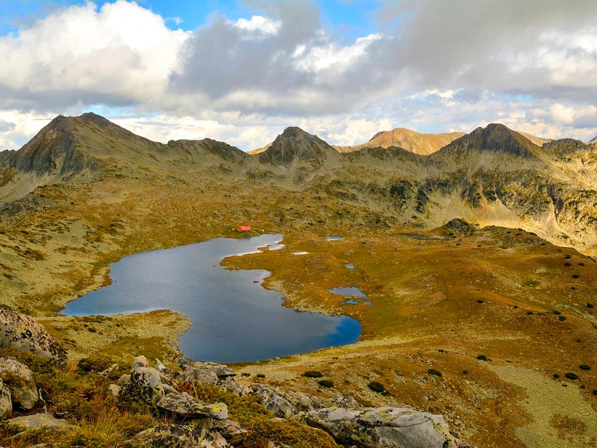 Tevno lake and shelter. The route comes from the saddle left from the pointy peak through the shelter and descends down to the right