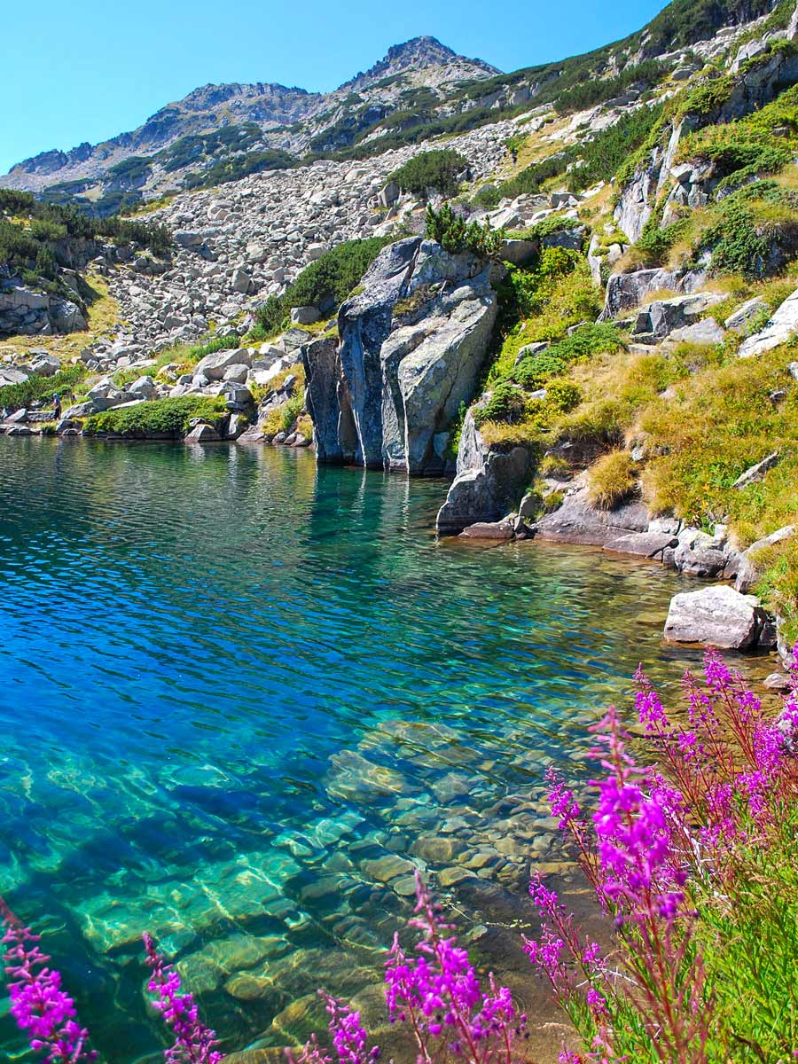 Popovo Lake the largest in Pirin range. The route goues across the boulders ahead and to the right