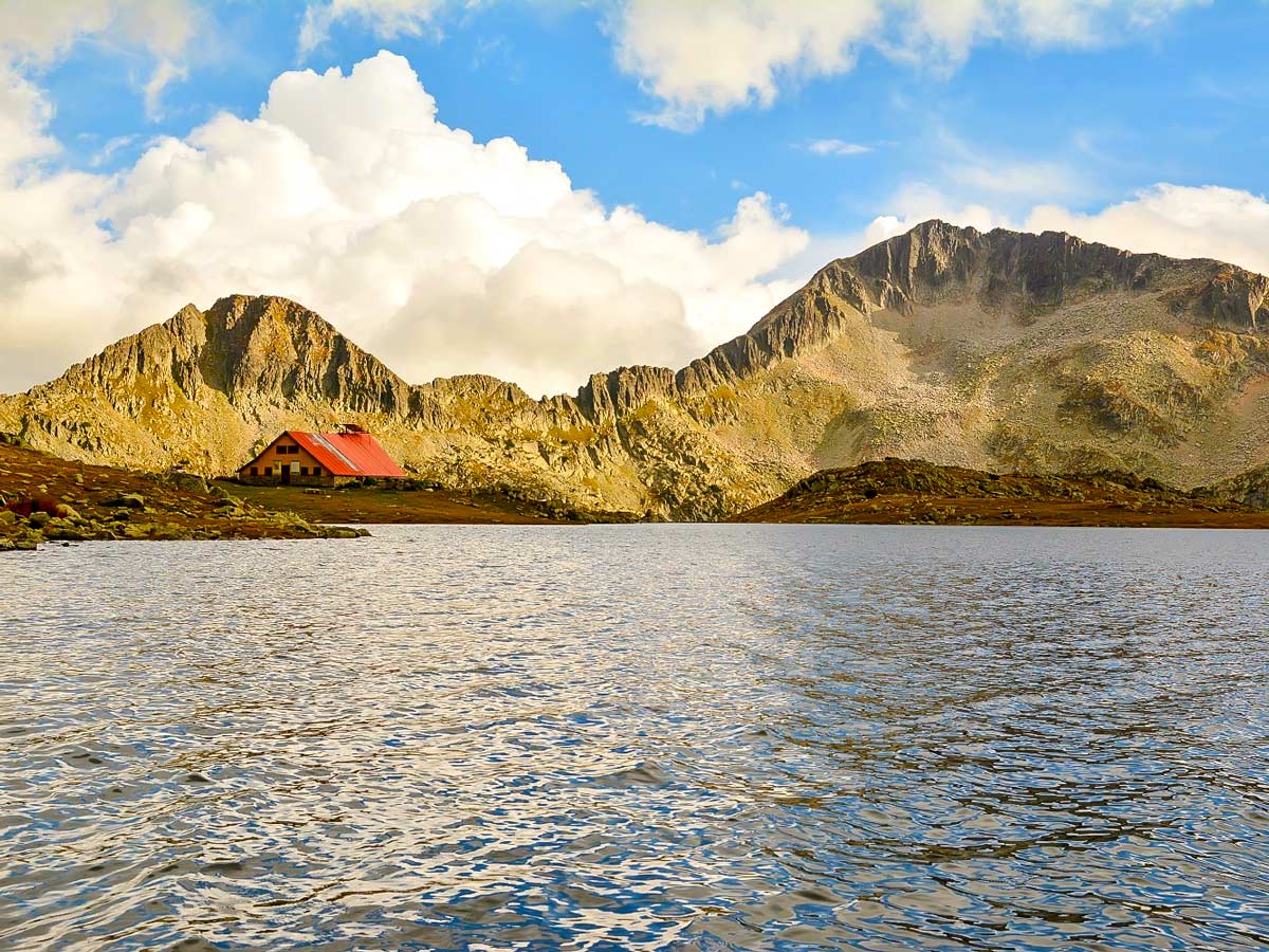 The dark Lake with the shelter and the imposing Mt Kamenitsa