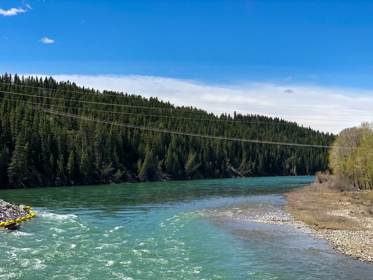 Beautiful turquoise waters of the Bow River seen while cycling to Bowness Calgary