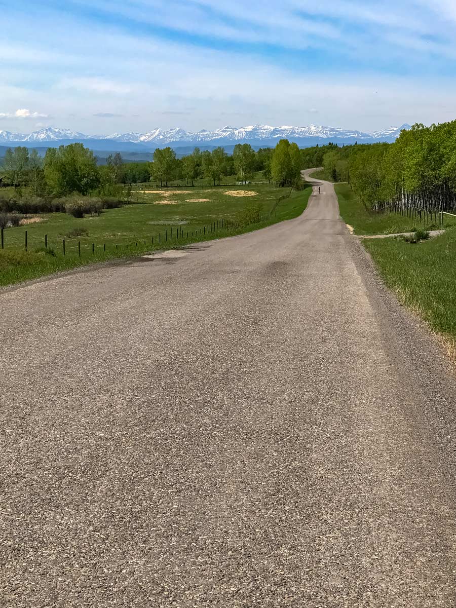 Rocky mountains in the distance along beautiful bike ride from Calgary to Dewinton