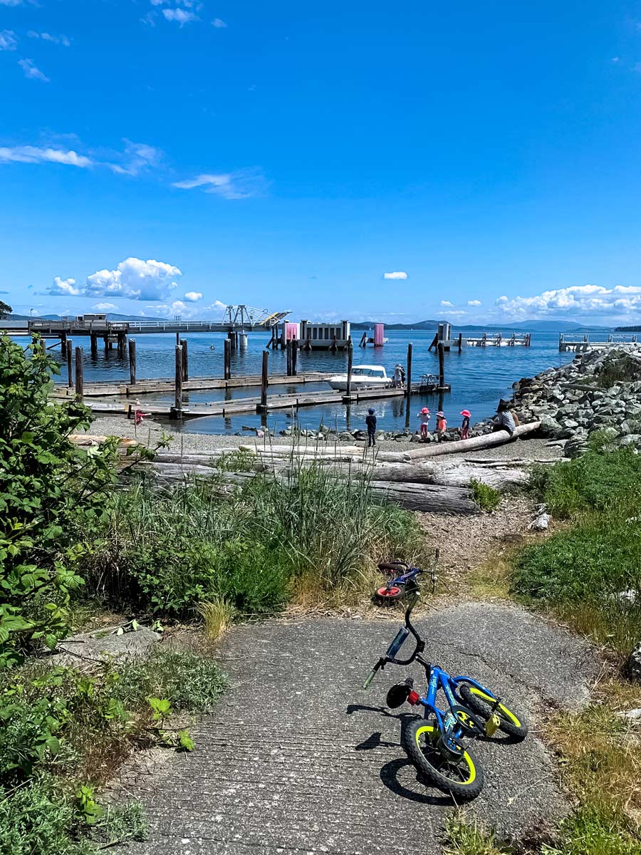 Kids biking Peninsula Loop trail play by the ocean near Victoria BC