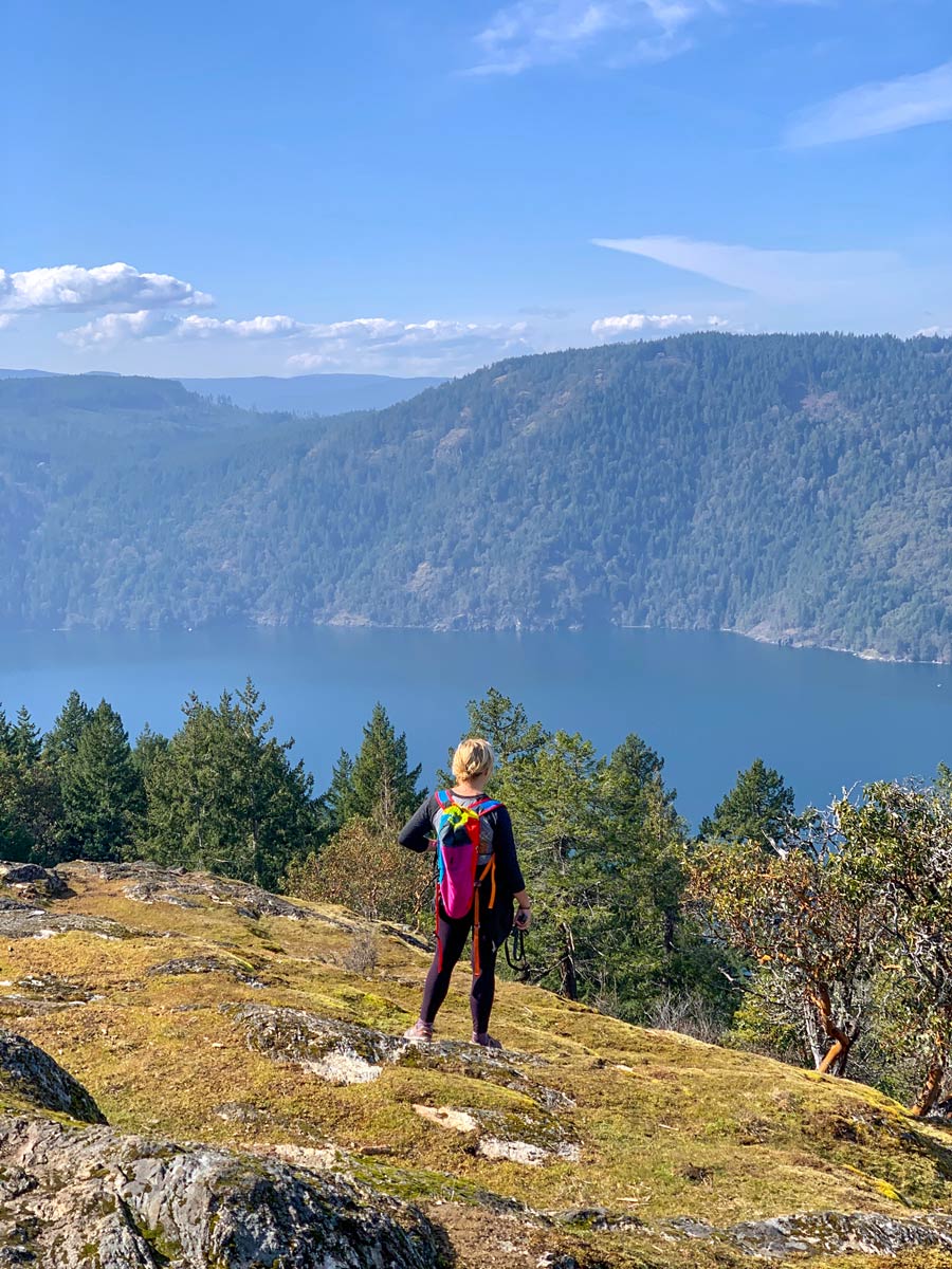 Hiker looking at rugged shores near Victoria BC