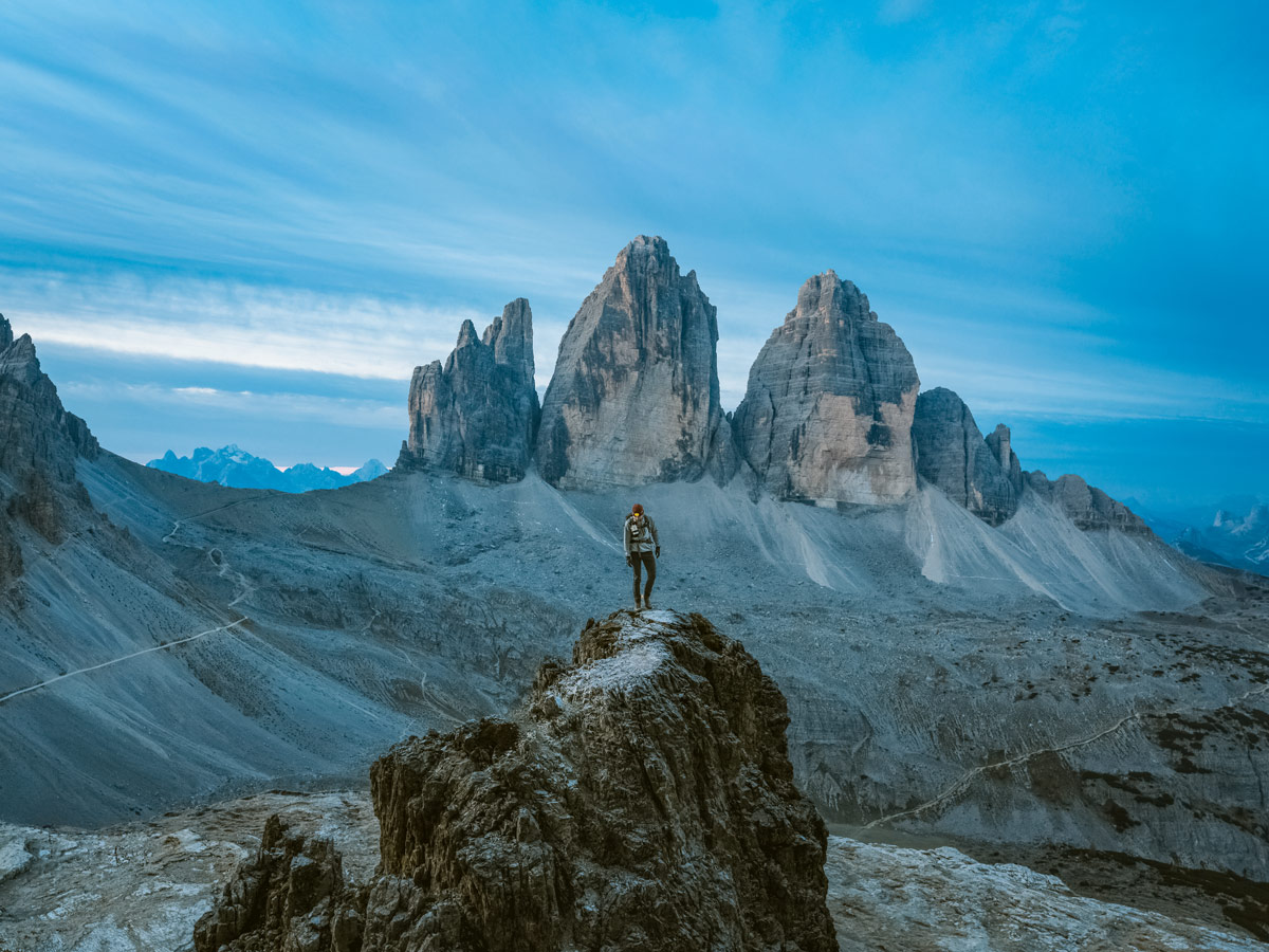 Beautiful mountain peaks hiker standing on summit in italy