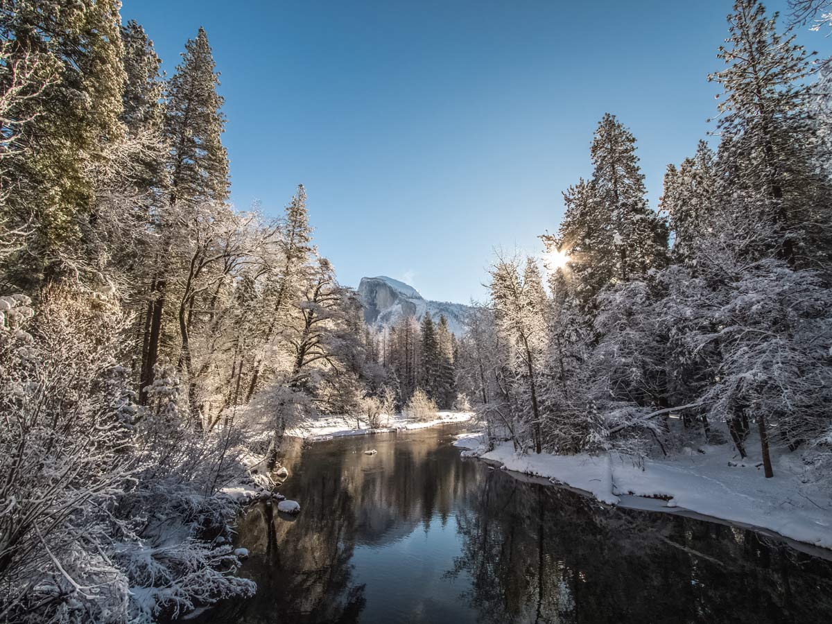Beautiful sunny winter day snow and river in Yosemite National Park USA