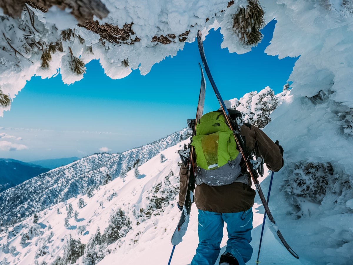 Hiker climbing up on the snow