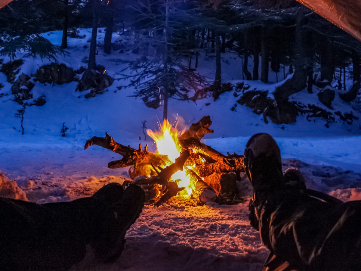 Campfire from the tent keeping warm winter camping hiking