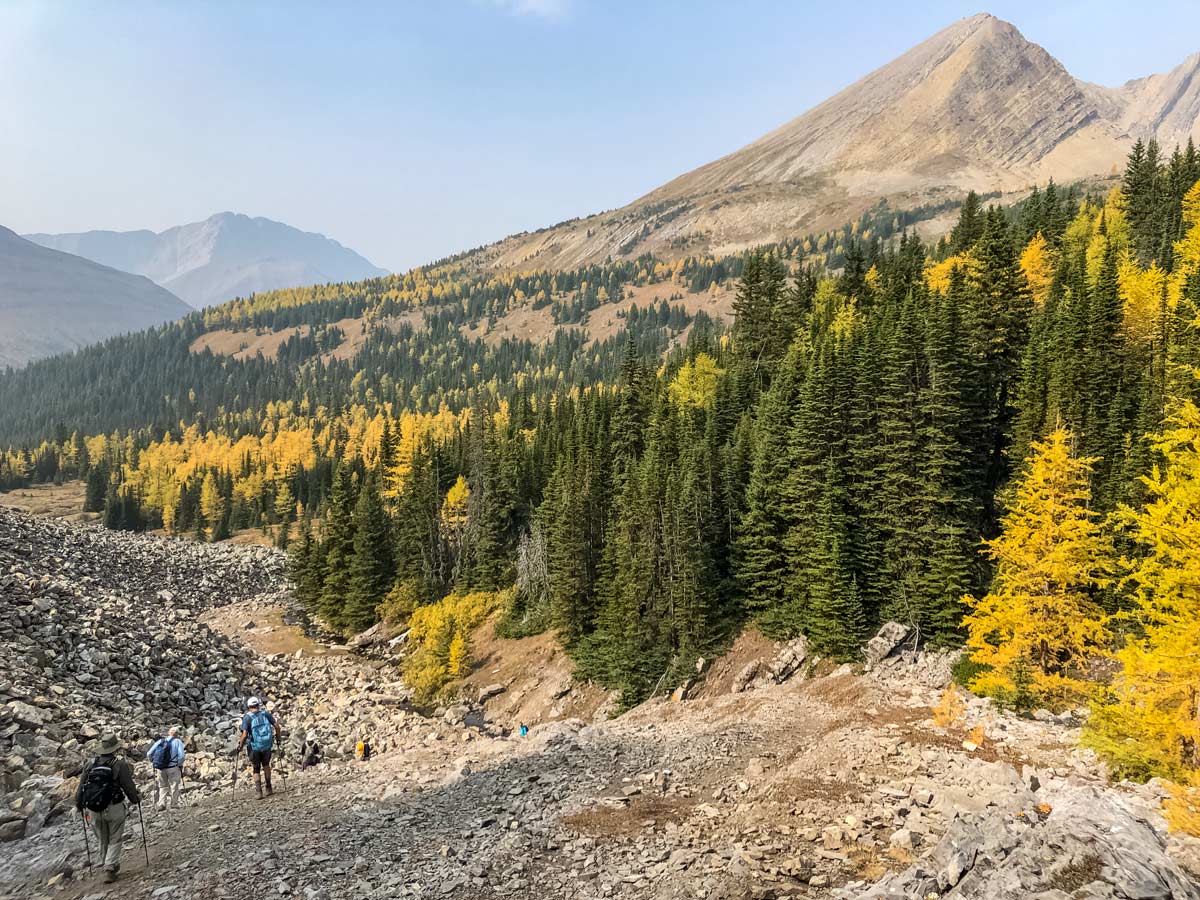 Hikers descens Arethusa Cirque hiking trail in Kananaskis alberta