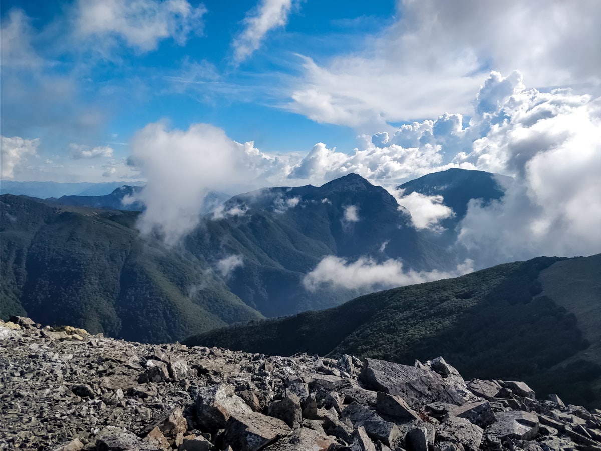 Low hanging clouds around mountains seen hiking Te Araroa trail trek in New Zealand