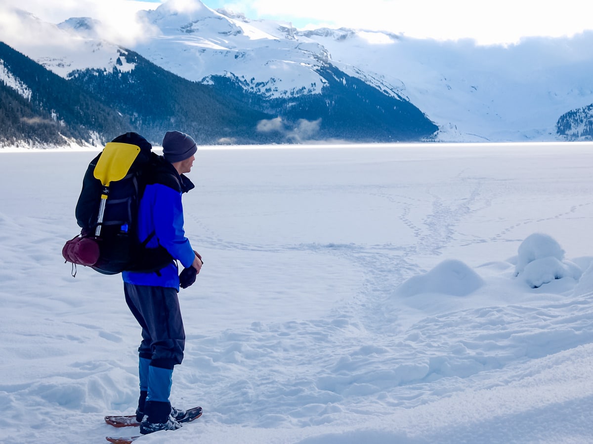 Winter snowshoe adventure around frozen lake near Vancouver Canada