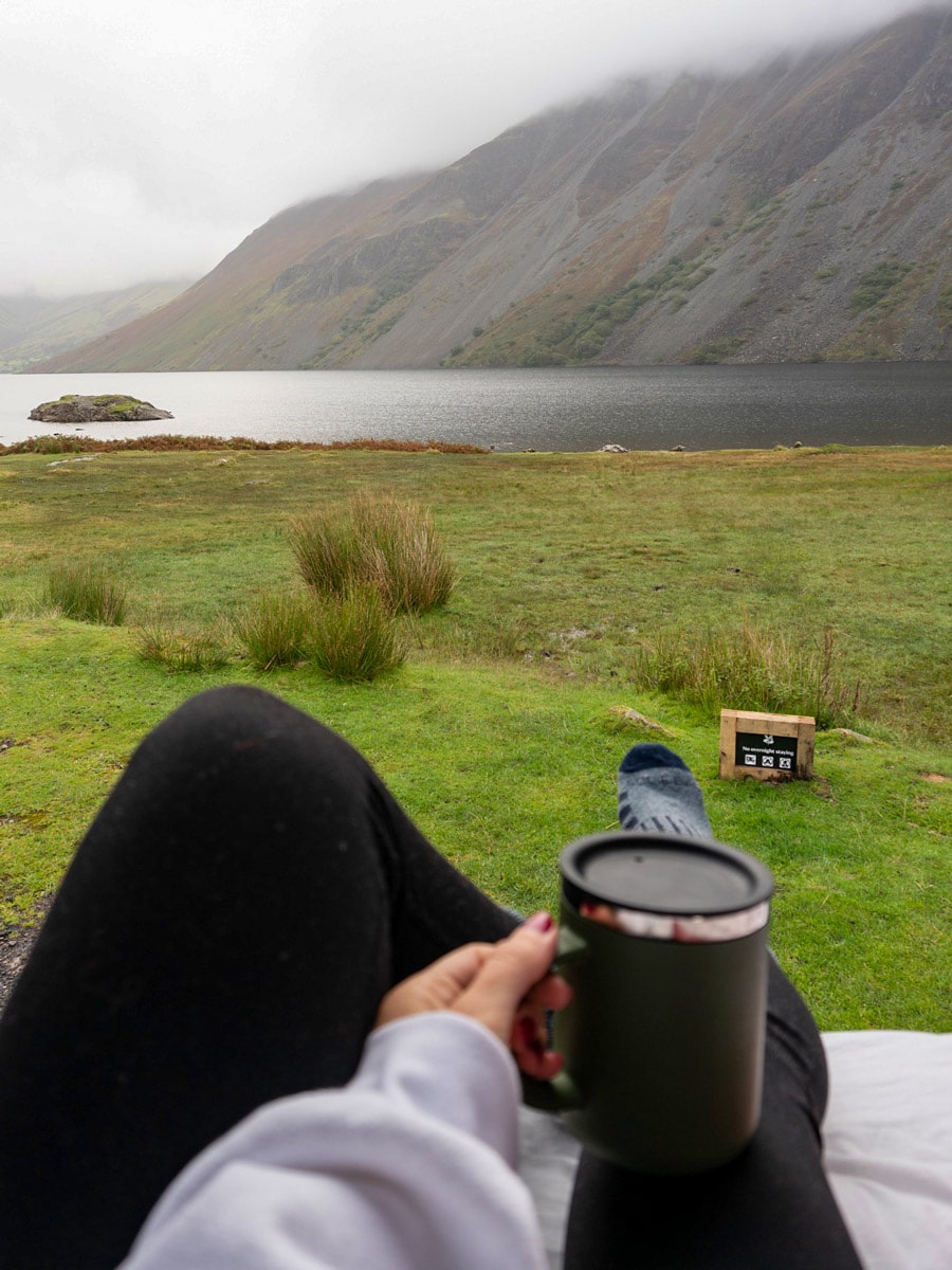 Morning coffee camping by fog mountains water shore in the UK Lake District