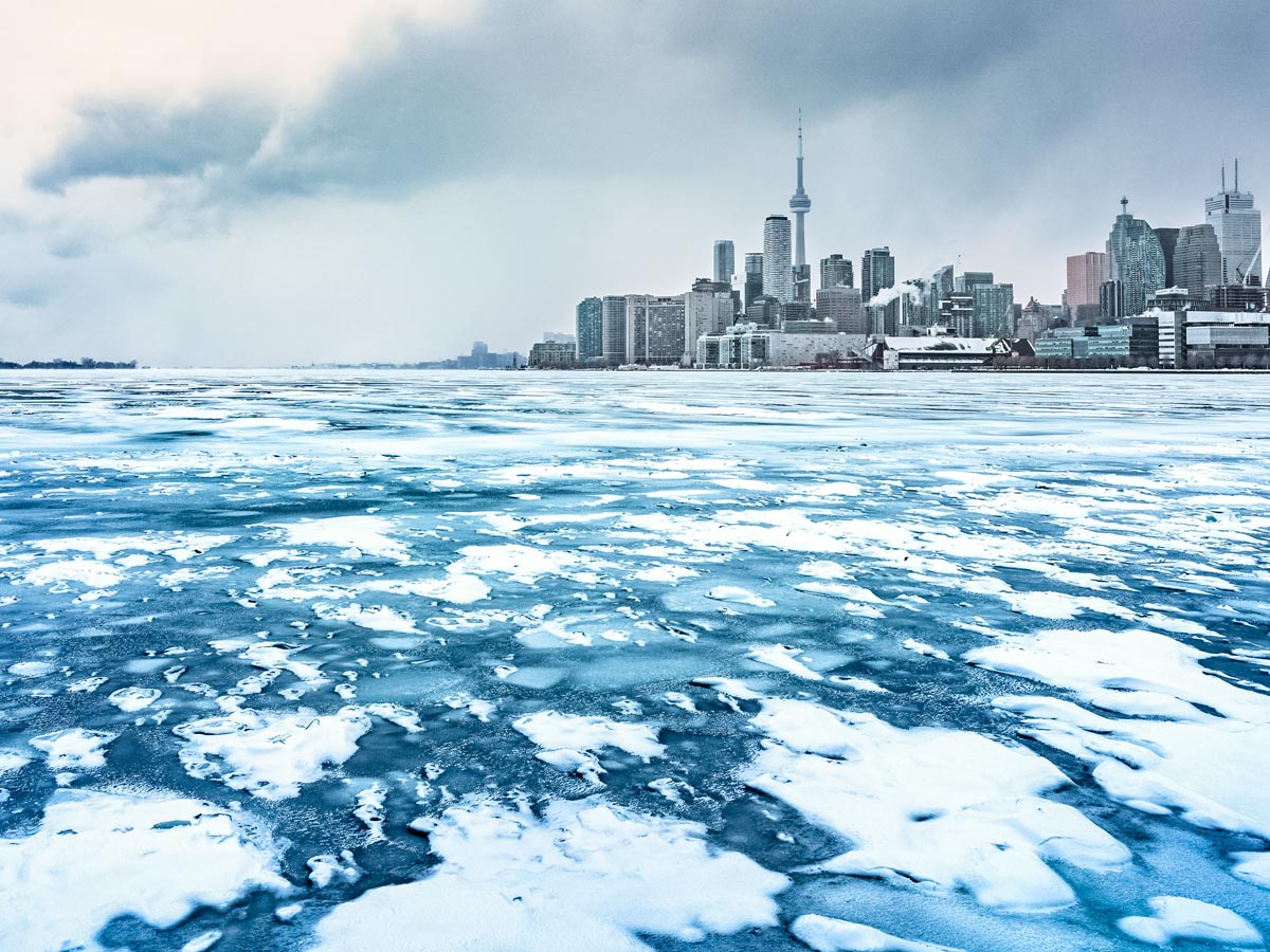 Frozen water surrounding downtown Toronto in winter