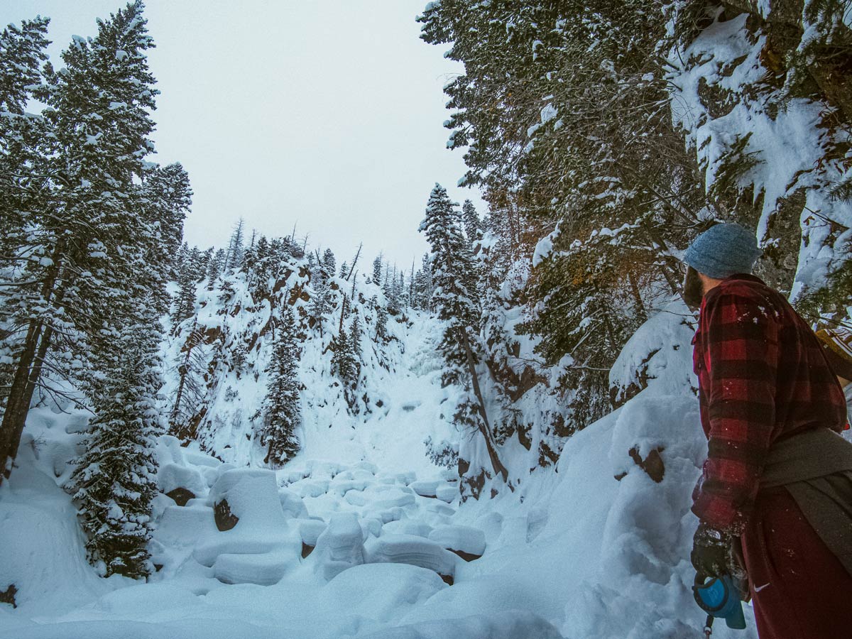 Winter hiking in the snow to frozen waterfalls pillows nears Denver Colorado