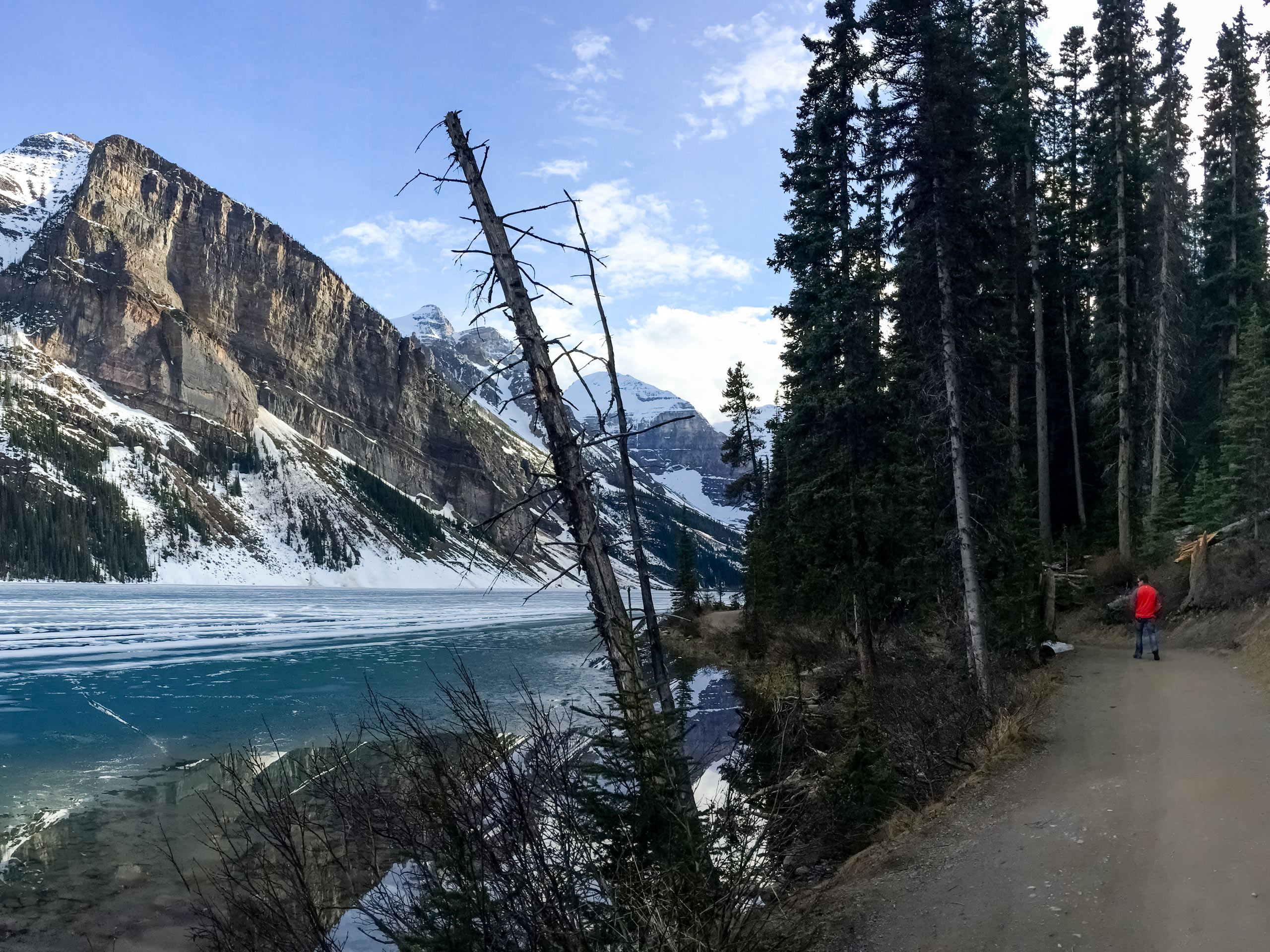 Hiker at Lake Louise shoreline Banff National Park