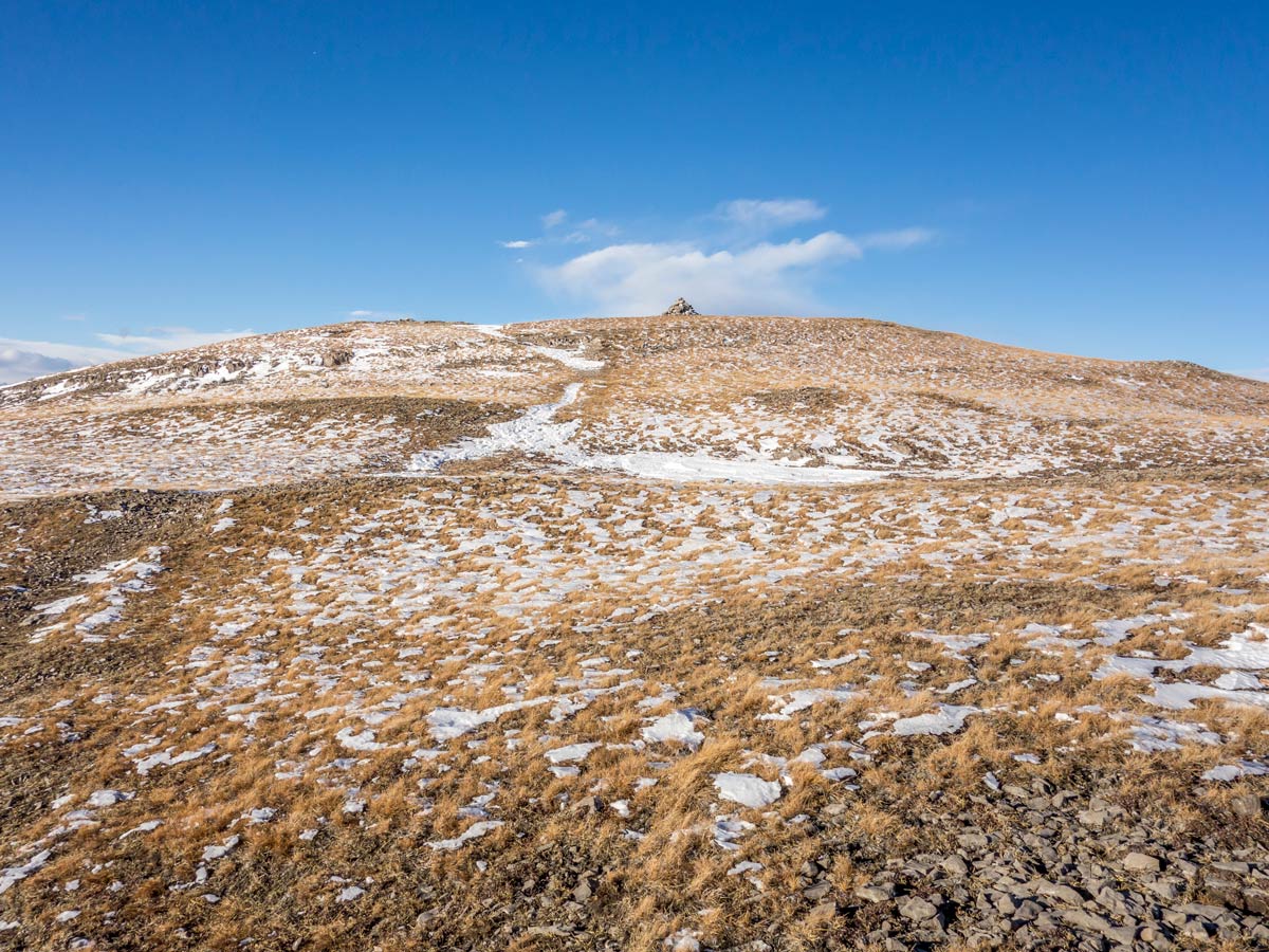 Approaching the cairn on the summit of Coliseum Mountain scramble near Nordegg, Alberta