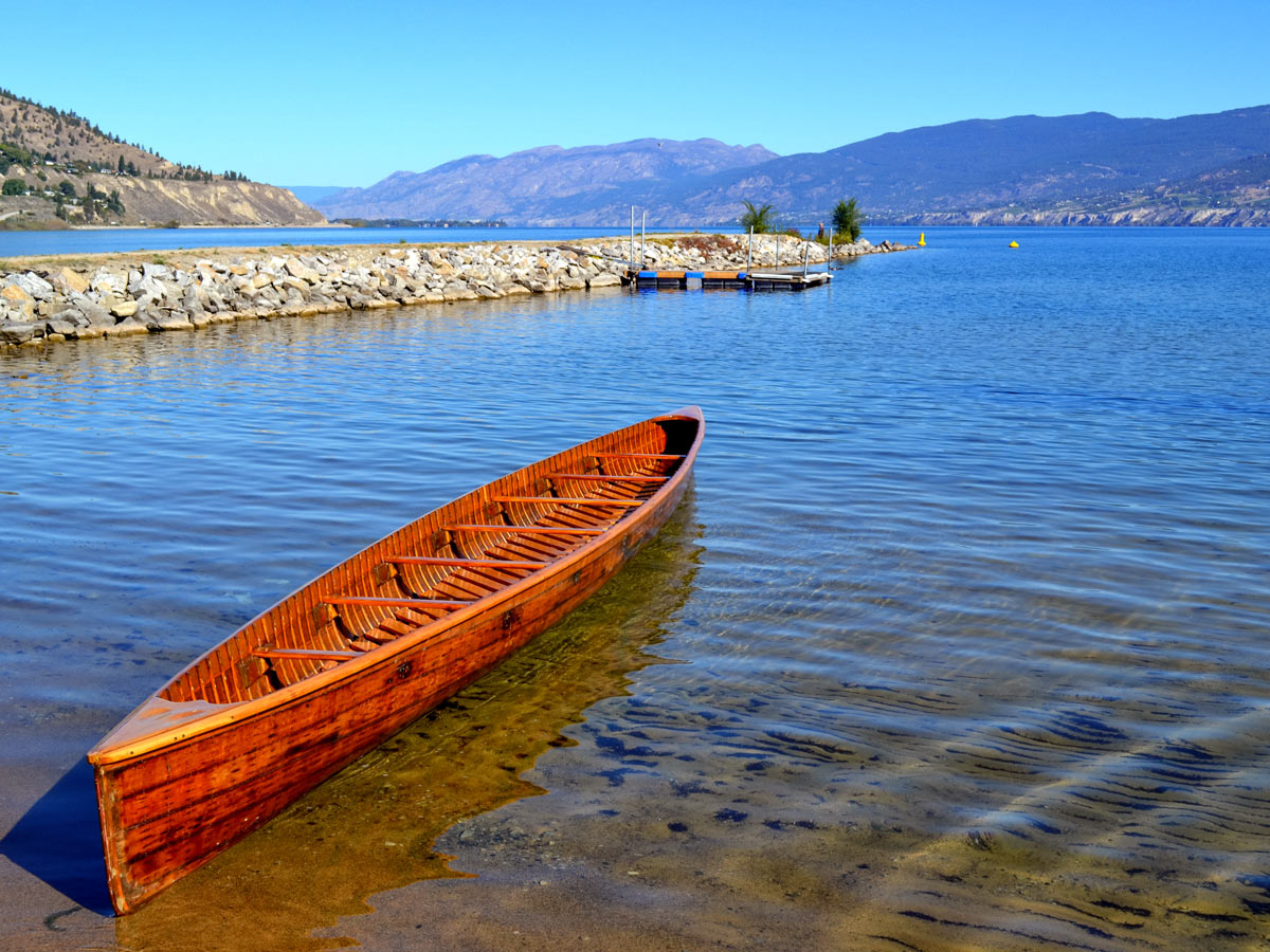 Okanagan lake old wooden canoe on the shore Kelowna British Columbia Canada