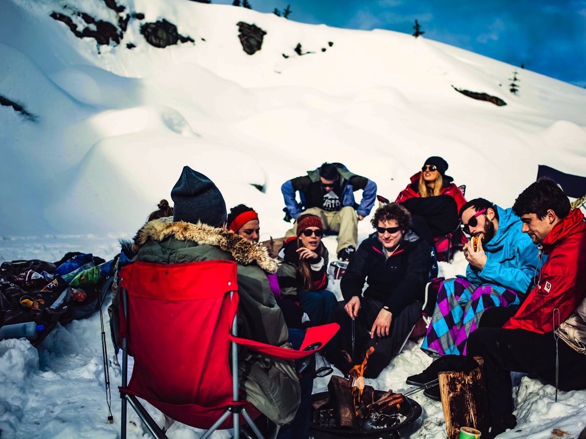 Friends hiking in the snow winter campfire