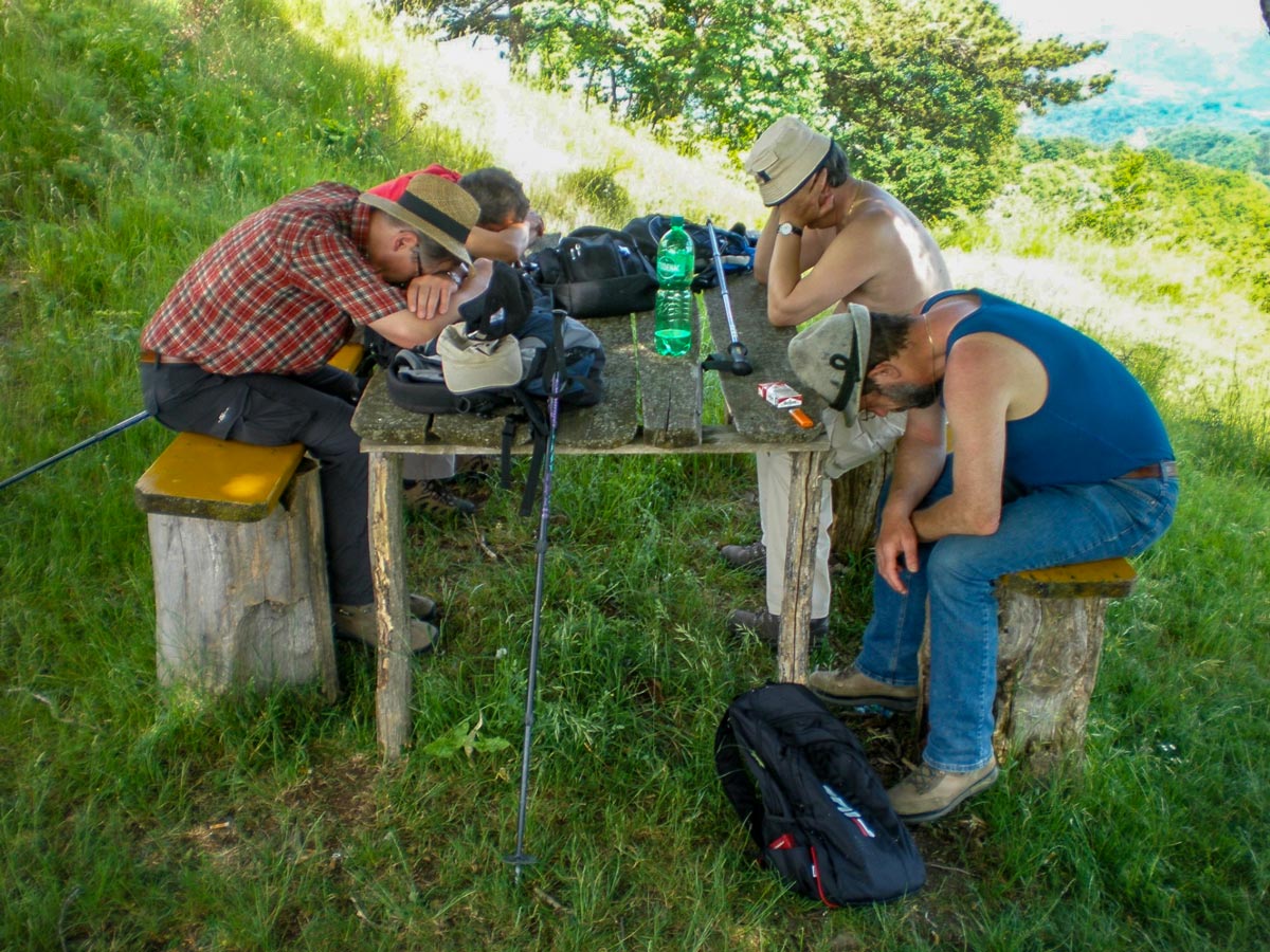 Tired hikers falling asleep at the table