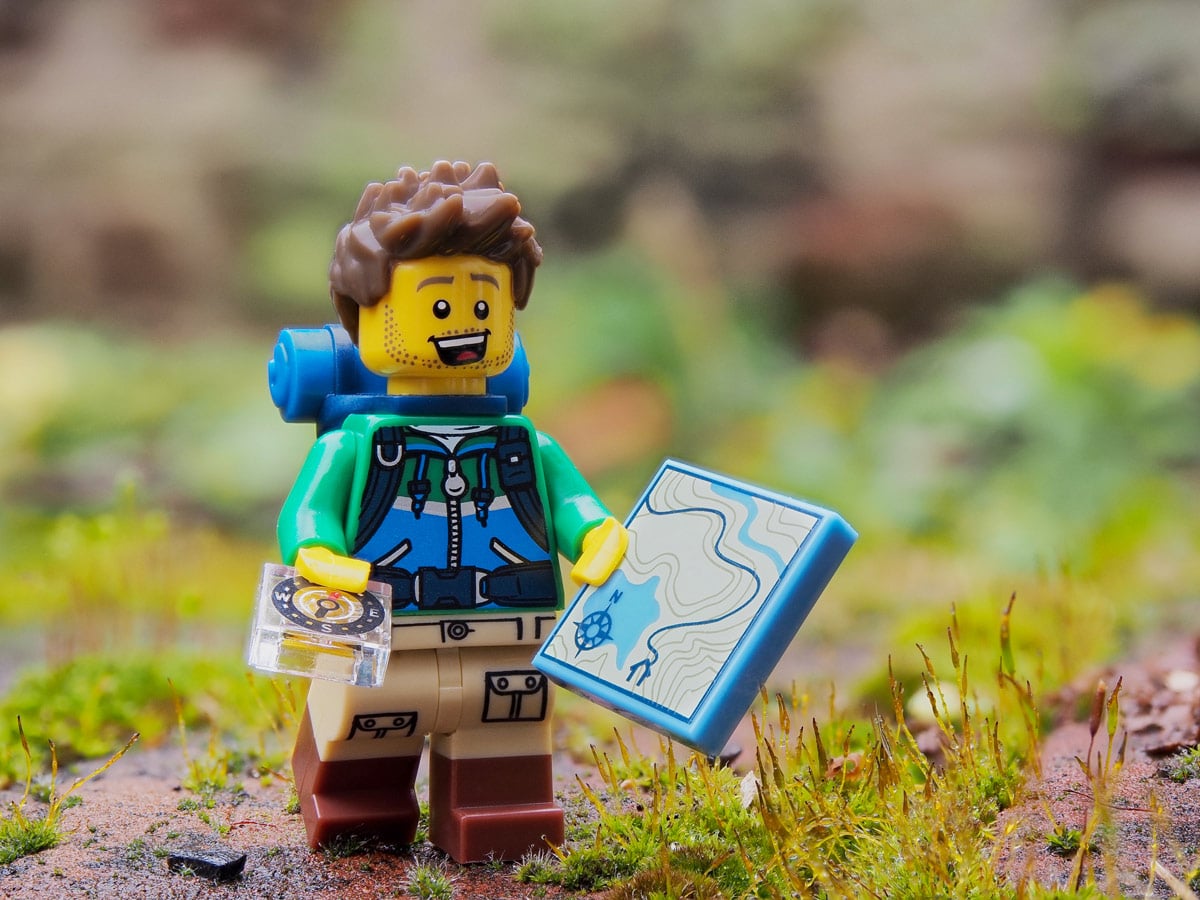 Lego hiker prepared with map and compass