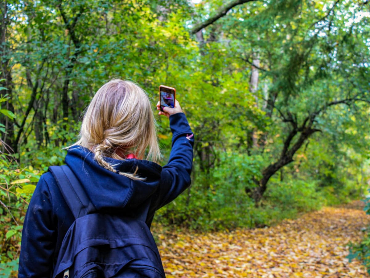 Hiker taking a selfie in the forest