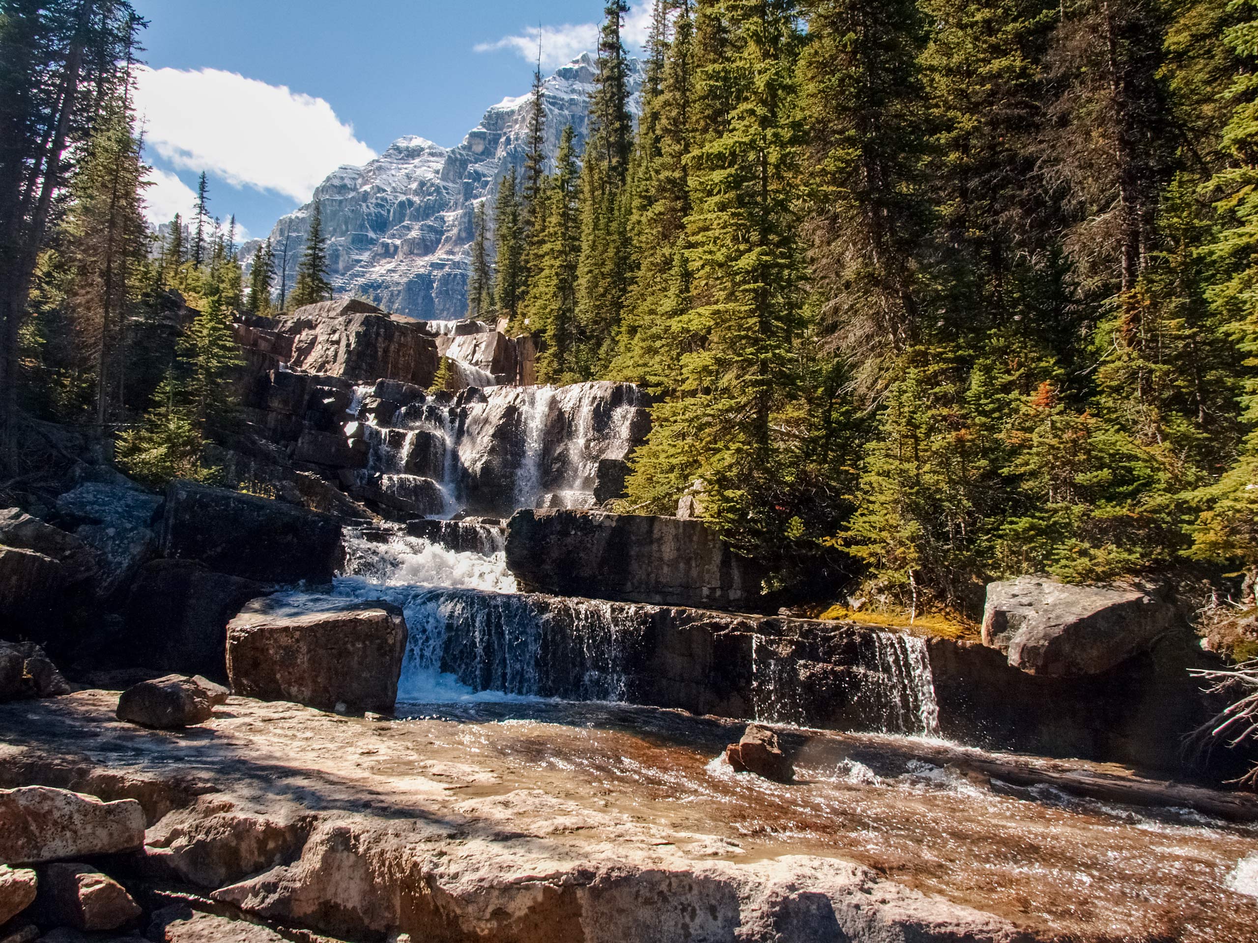 Natural stone block waterfalls hiden in the forest of the rocky moutains Banff National Park