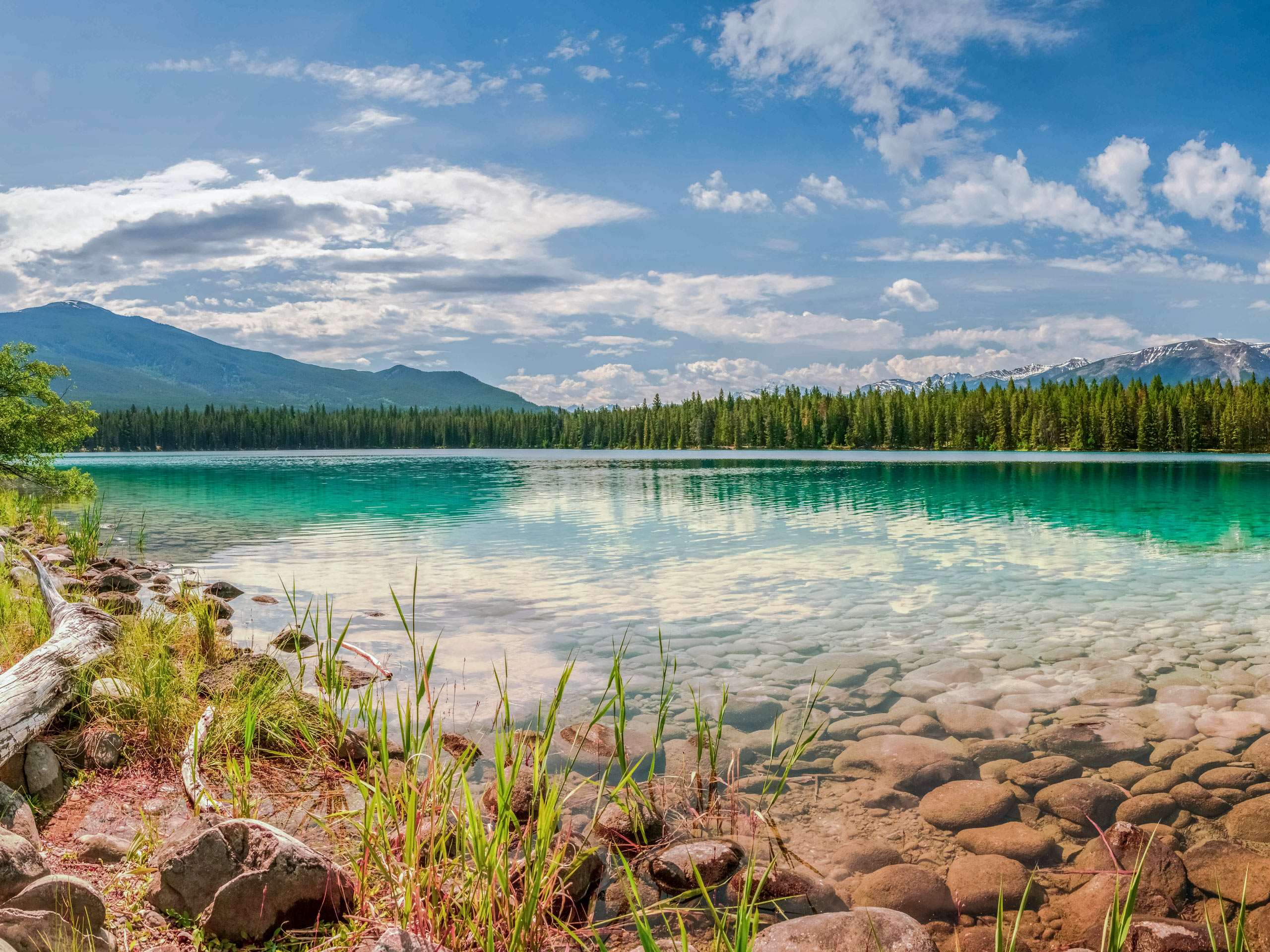 Clear emerald waters of Lake Annette hiking Jasper National Park