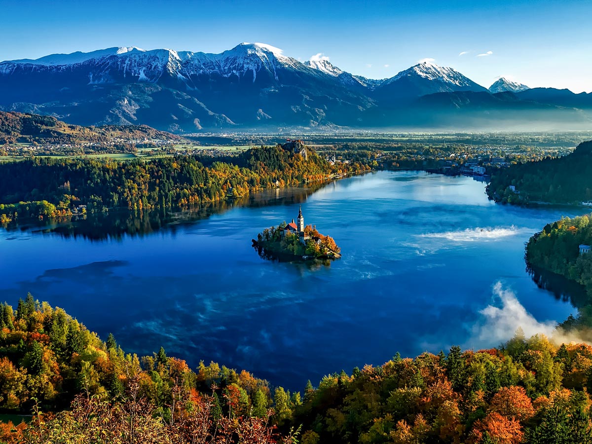 Lake Bled church on the Island Slovenia Fall forest and mountains