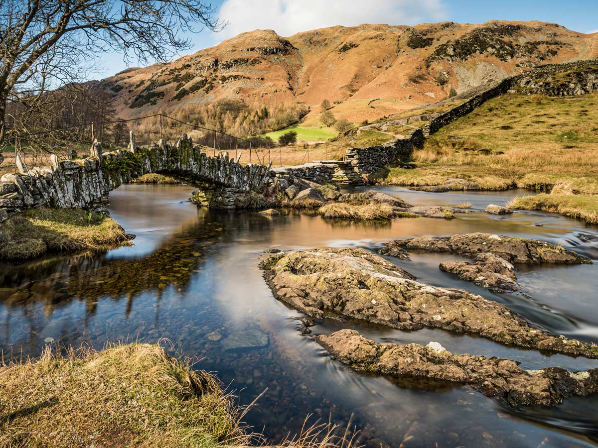 Lake District hiking Little Langdale Cumbria Slater Bridge stone walking bridge over small river