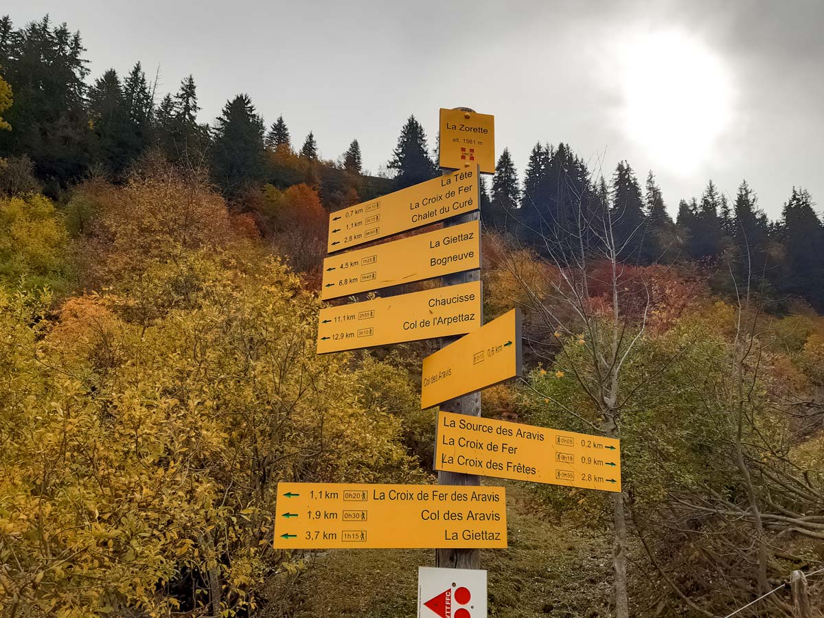 Signpost at wooden panel Col Des Aravis hiking trails in France