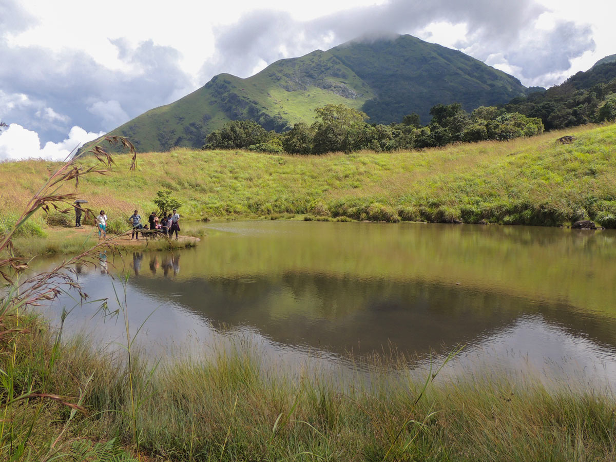 Hikers stand by pond along Chembra Peak Hikes