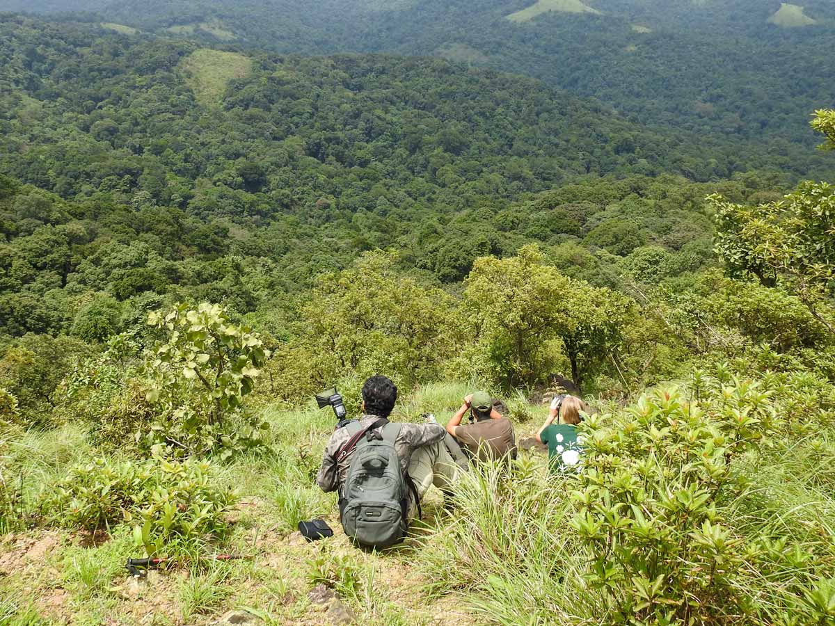 Hikers rest on hillside Makki Hills India