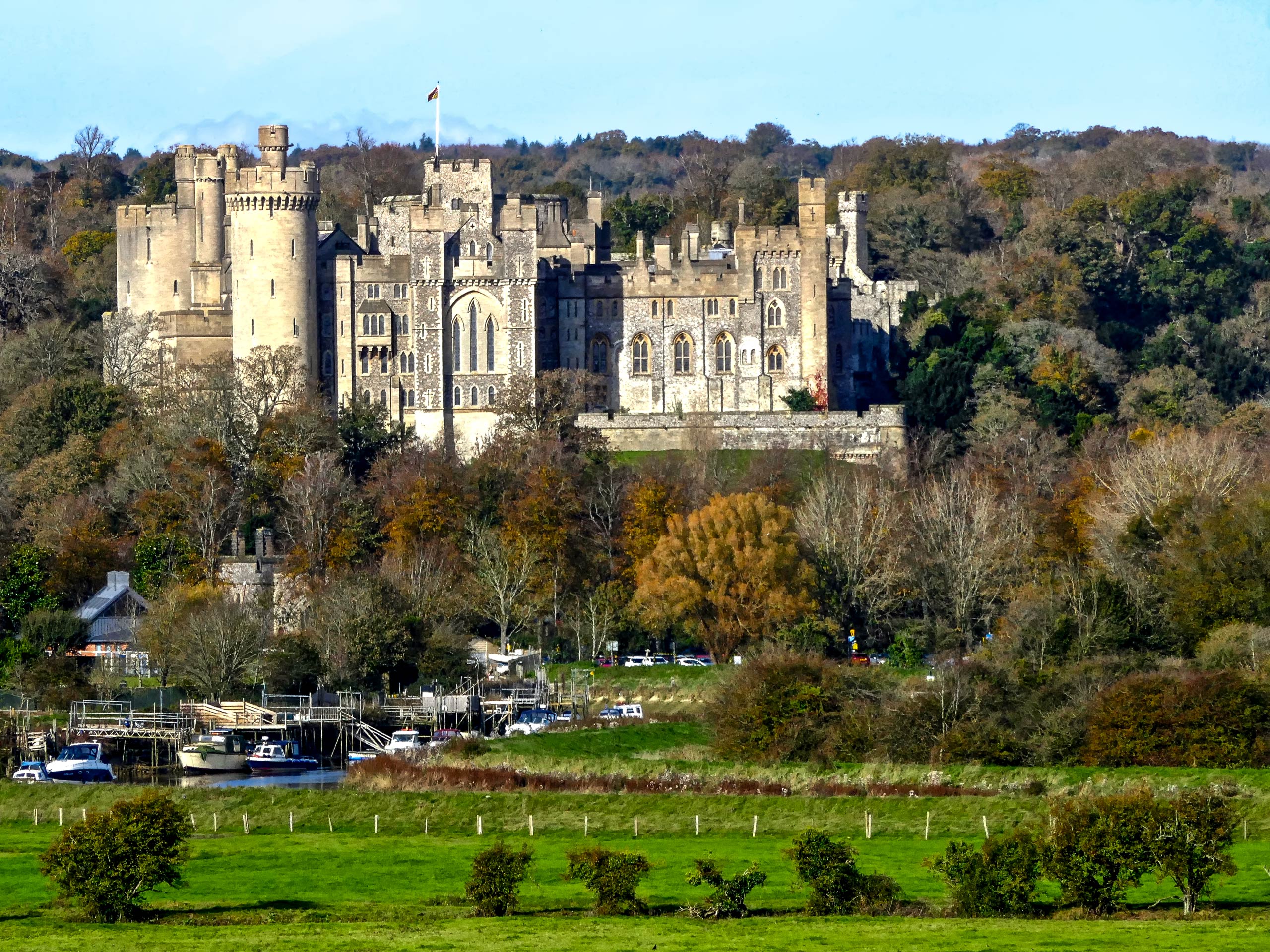 Arundel Castle on the hill above small harbour South Downs UK