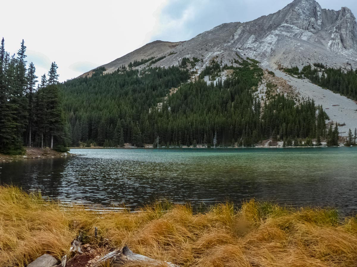 Turquoise rocky mountain lake along Edworthy Falls trail in Kananaskis Alberta