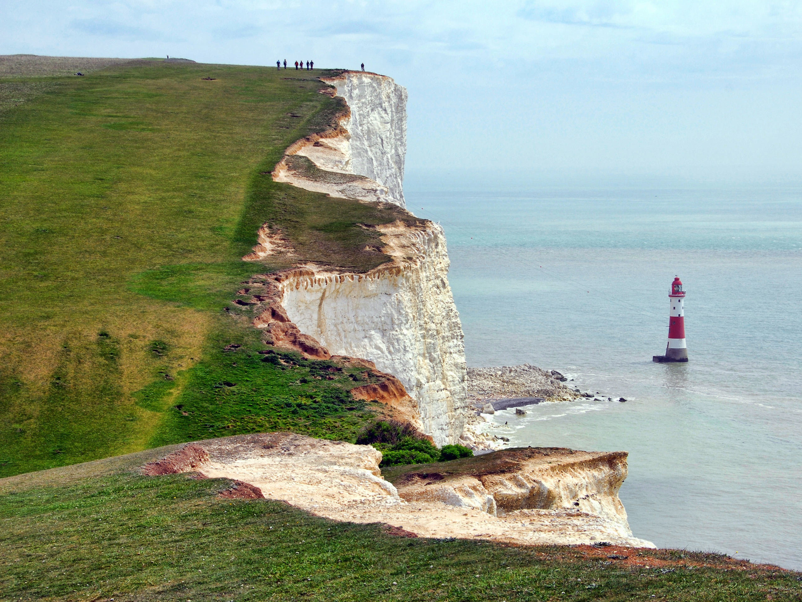 Lighthouse in the ocean by cliffs Eastborne Downland South Downs