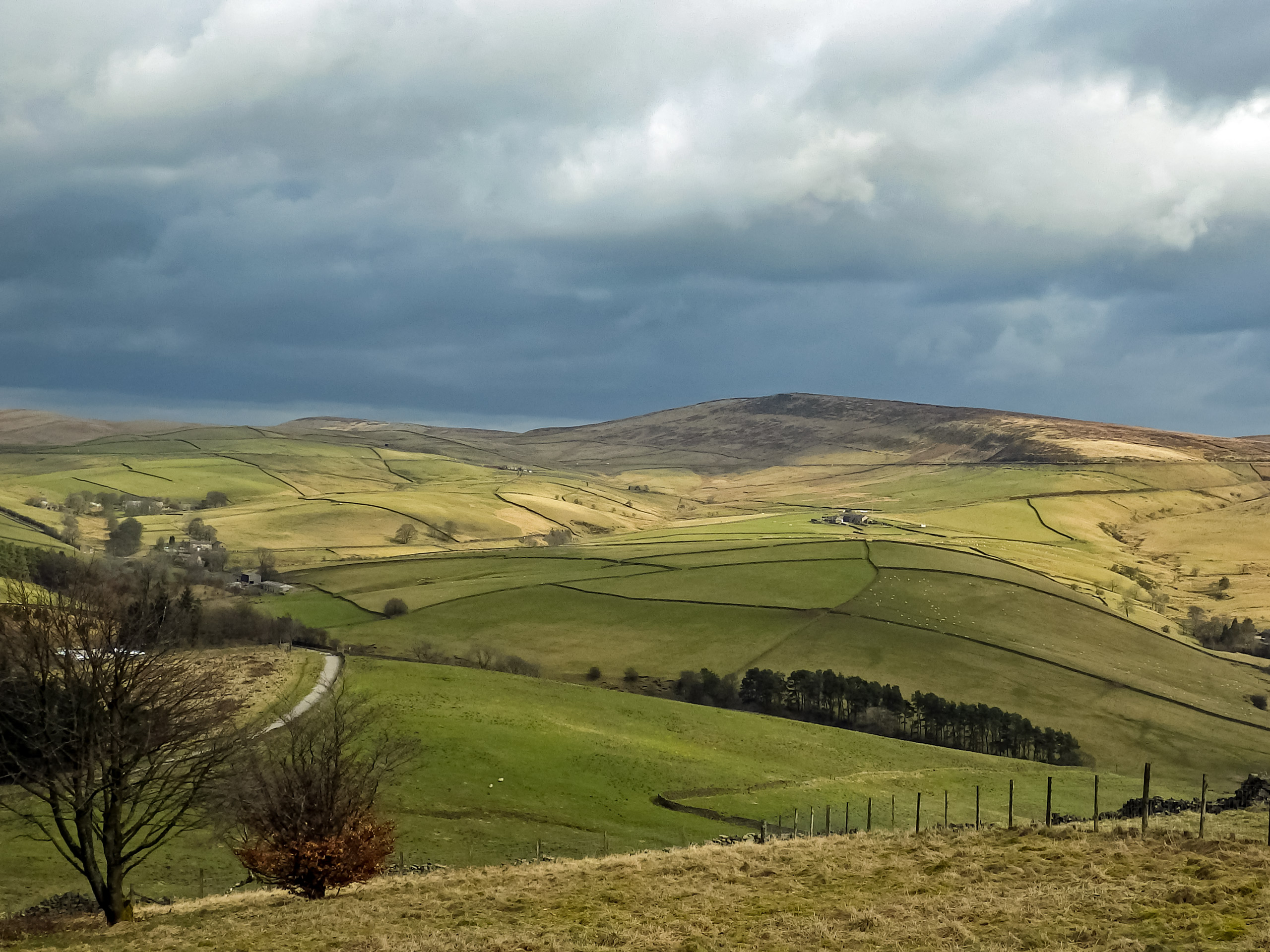 Sprawling fields under grey cloudy sky Shining Tor Circular Walk Peak District National Park UK