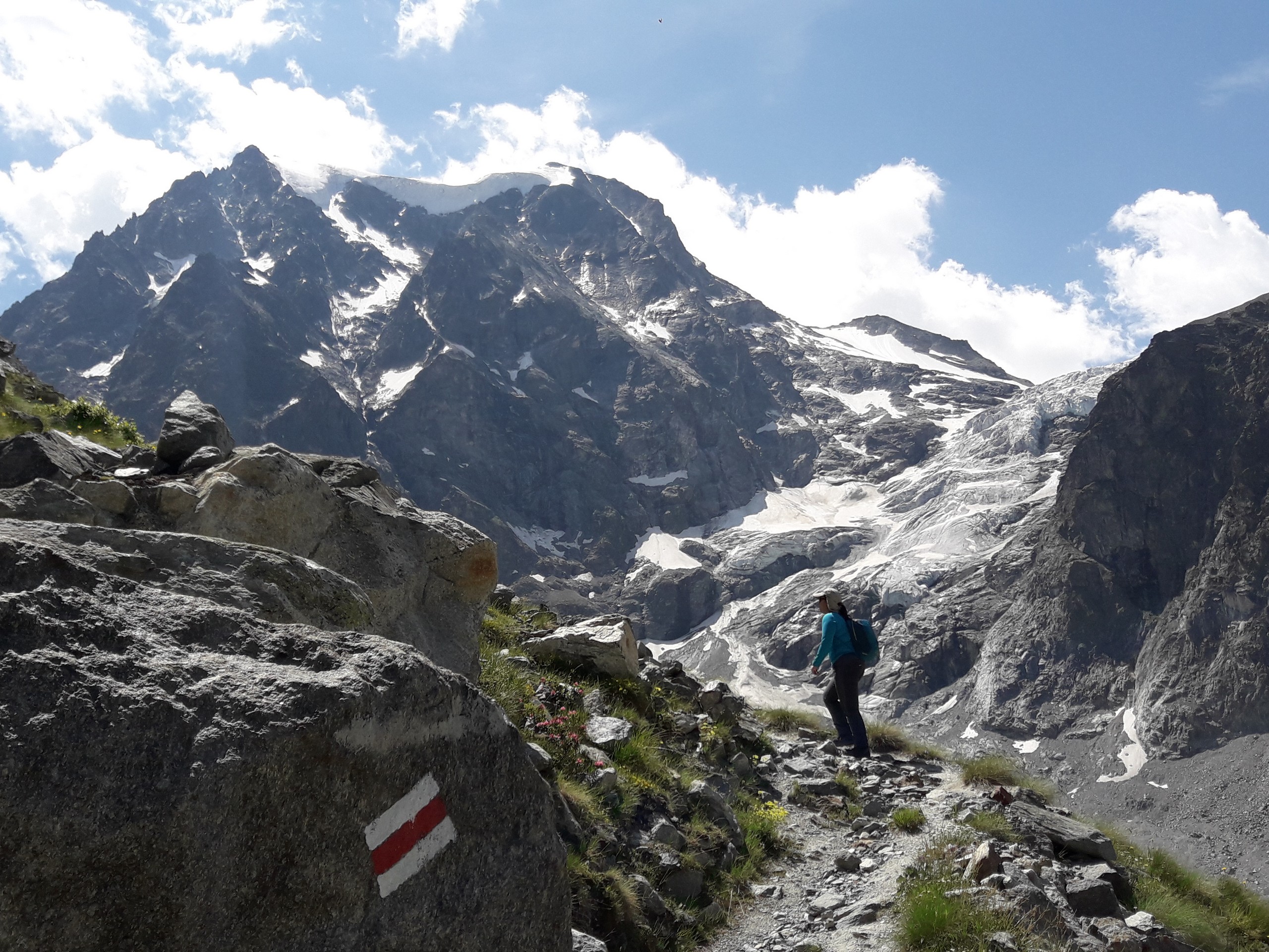 Hiker approaching the Arolla Glacier in Switzerland