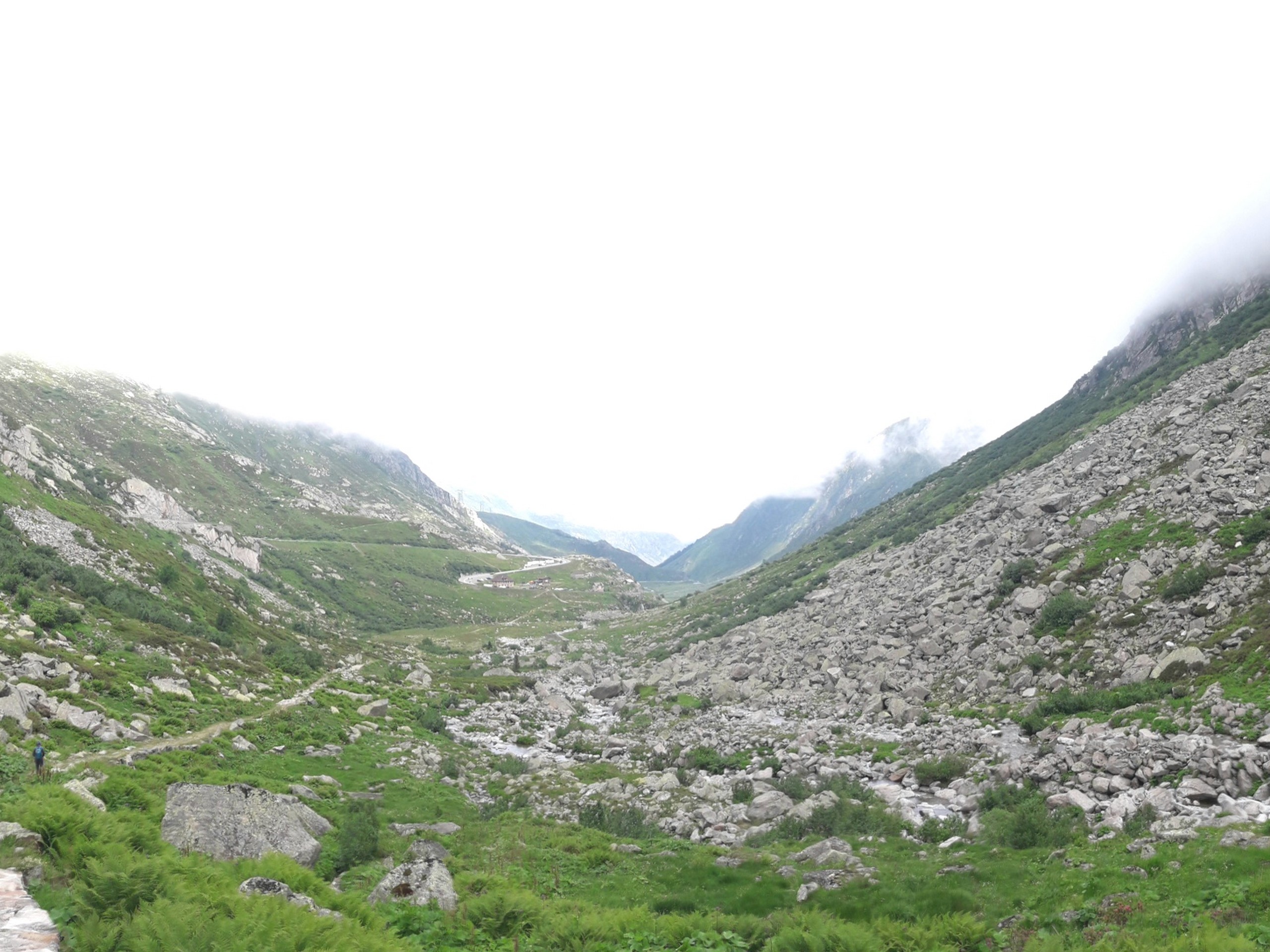 Walking down the valley on Passo del Gothardo to Hospental trail