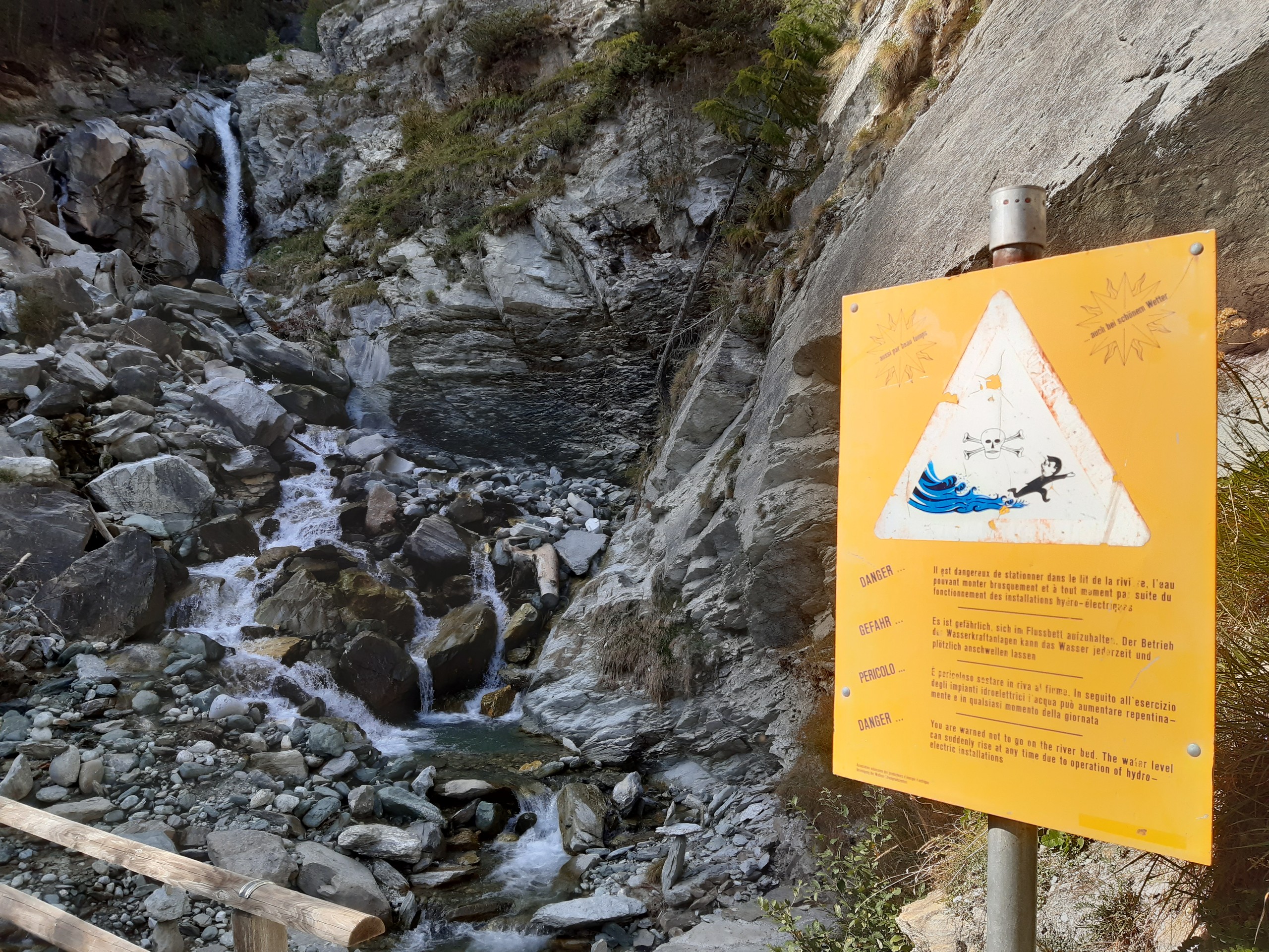 Warning sing at bridge over the waterfall