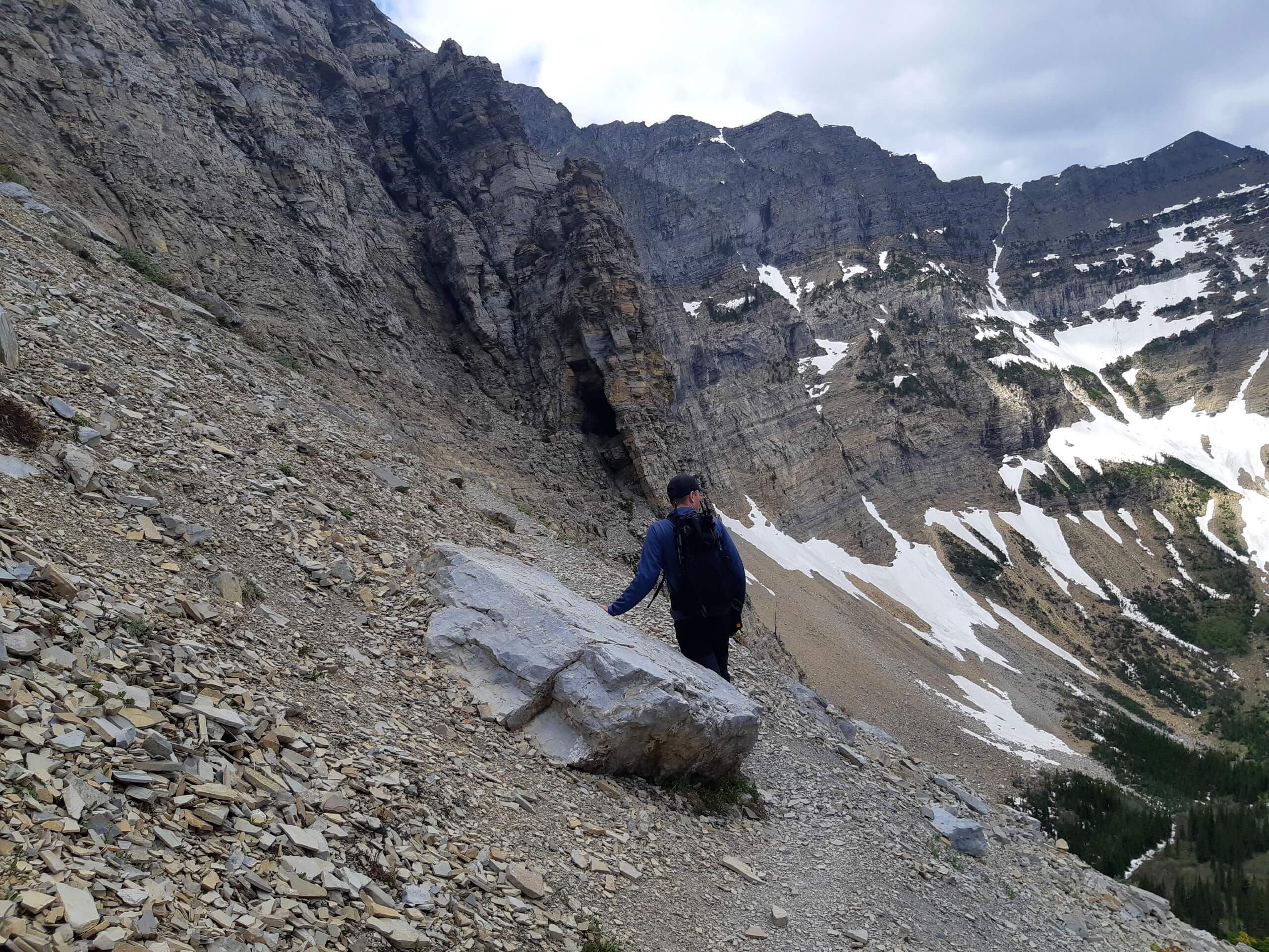 Hiker approaching the cave on Crypt Lake Hike