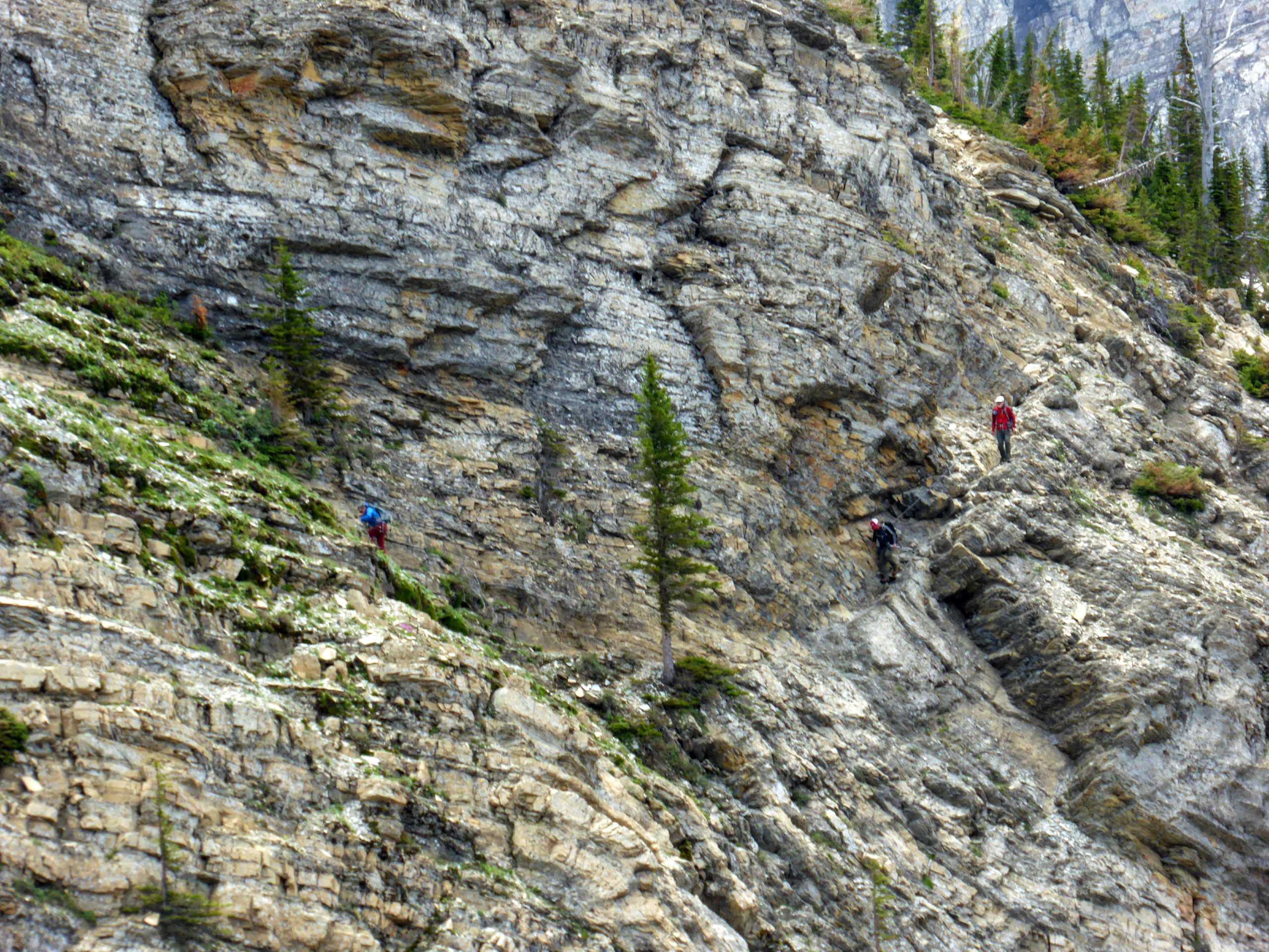 Hikers on a chain part of the trail to Crypt Lake